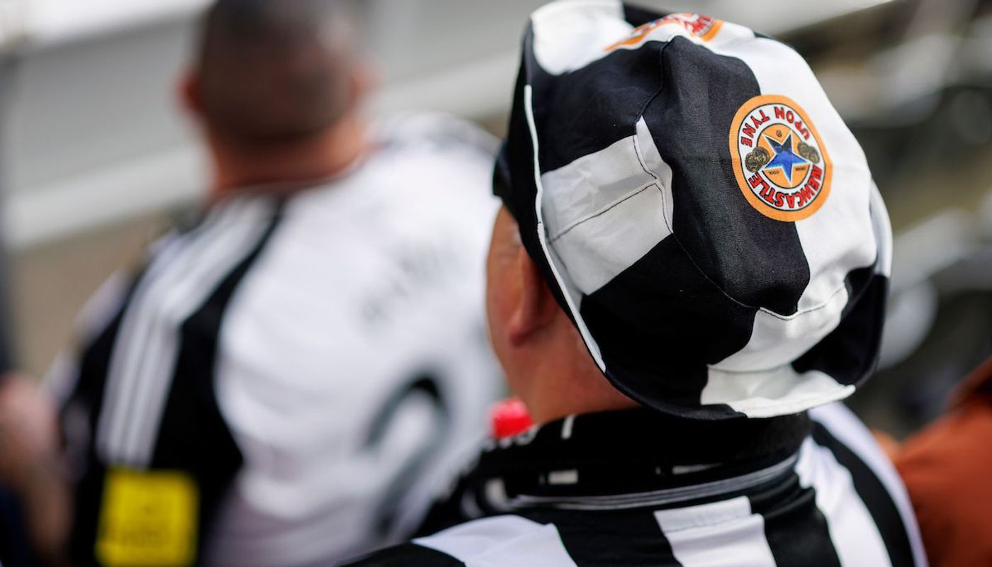 15. A Newcastle fan shows off his true stripes